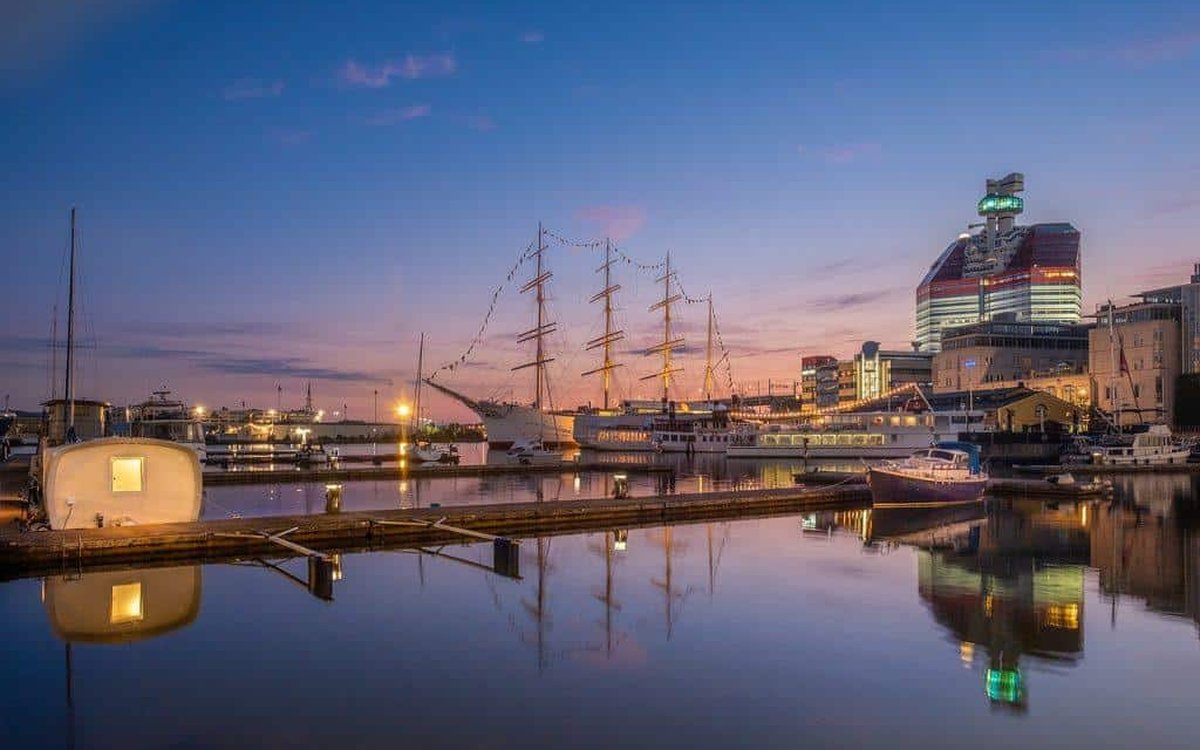 Gothenburg harbour at dusk with a tall ship and the Lipstick building